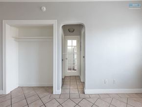 Los Angeles apartment for rent - A white room with a doorway leading to another room.