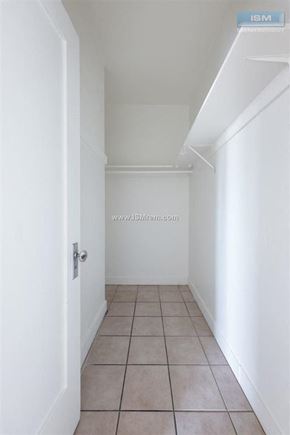 Los Angeles apartment for rent - A white hallway with a tiled floor and a door on the left.