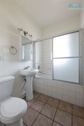 Los Angeles apartment for rent - A white toilet sits next to a sink in a small bathroom.