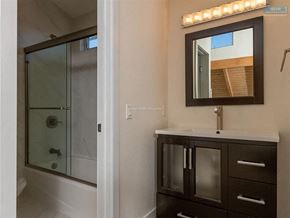 Los Angeles apartment for rent - A bathroom with a mirror and lights above it.