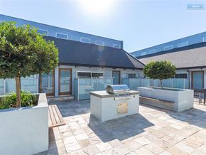 Los Angeles apartment for rent - A sunny day at a modern building with a BBQ grill in the courtyard.