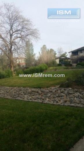 Redding apartment for rent - A stone pathway leads through a grassy area.