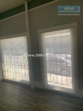 San Francisco apartment for rent - A room with a window showing a car and a building outside.