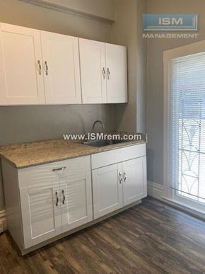 San Francisco apartment for rent - A kitchen with white cabinets and a countertop.