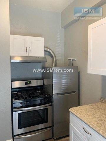 San Francisco apartment for rent - A kitchen with a stove and a refrigerator.