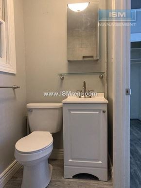 San Francisco apartment for rent - A white toilet and cabinet in a bathroom.