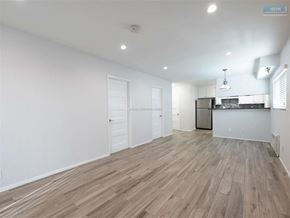 Sherman Oaks apartment for rent - A spacious room with wooden flooring and white walls.