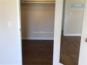 Stockton apartment for rent - A room with a wooden floor and a door leading to another room.