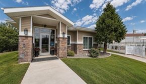 Elko apartment for rent - A small building with a stone pillar and a glass door.
