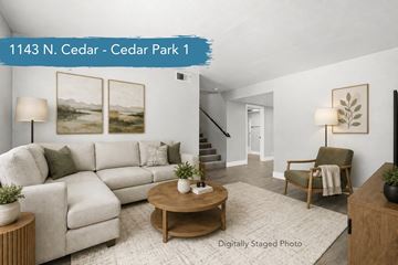 Chico apartment for rent - A living room with a white couch, a coffee table, and a painting on the wall.