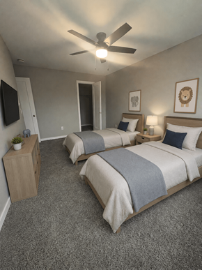 Champaign apartment for rent - A bedroom with two beds and a ceiling fan.