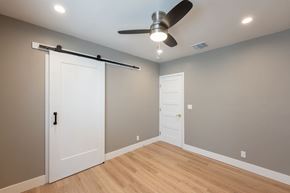 Los Angeles apartment for rent - A room with a sliding door and a ceiling fan.