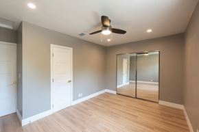 Los Angeles apartment for rent - A room with a ceiling fan and mirrored door.