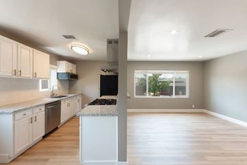 Los Angeles apartment for rent - A kitchen with white cabinets and a black fridge.