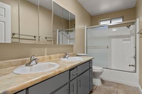 Chico apartment for rent - Bathroom with dual sinks and large mirror at Cedar Park Apartments, Chico, CA 95926