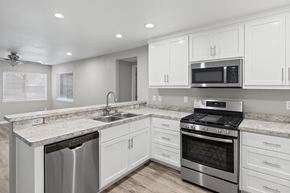 Chico apartment for rent - Modern kitchen with white cabinetry and granite countertops at OSM Properties Homes & Apartments, Chico