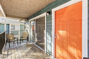 Private patio with outdoor seating and screen door