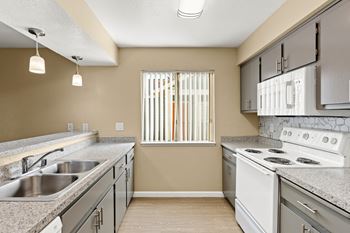 Galley kitchen with double sink and electric range