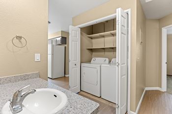 Bathroom vanity with laundry closet and shelving