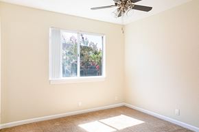 Chico apartment for rent - an empty room with a window and a ceiling fan at Creekview Homes, Chico, 95928