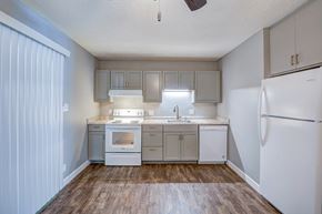 Redding apartment for rent - A kitchen with white appliances and wooden floors.