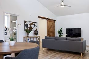 Napa apartment for rent - A living room with a grey couch, a wooden table, and a television.