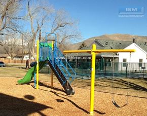 Carson City apartment for rent - A playground with a green slide and a yellow swing set.