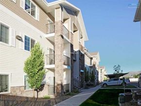 Elko apartment for rent - A row of modern apartment buildings with balconies and a clear blue sky.