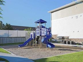 Elko apartment for rent - A playground with a blue slide and a wooden structure.