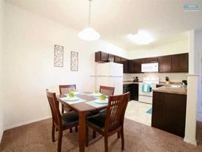 Elko apartment for rent - A kitchen with a table and chairs in the foreground.
