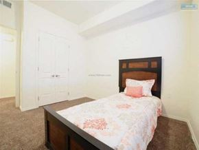 Elko apartment for rent - A bedroom with a bed, pillow, and carpet.