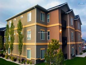 Elko apartment for rent - A modern two-story building with a balcony on the second floor.