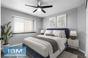 Chico apartment for rent - Staged bedroom with blue upholstered bed and white nightstands at Redwood Cove Apartments, Chico, California