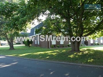 Columbia apartment for rent - A tree in front of a building with a sign that says www.lsmrem.com.