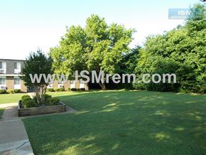 Columbia apartment for rent - A well-maintained lawn with a pathway and a small garden bed in the foreground.