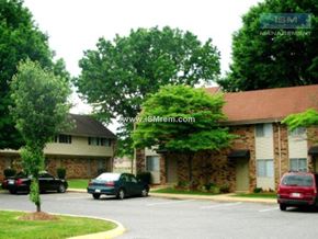 Johnston apartment for rent - A stone building with a green tree in front of it.