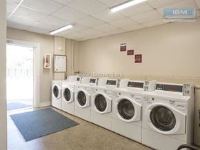 Johnston apartment for rent - A row of white washing machines are lined up in a room.