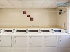 Johnston apartment for rent - A row of washing machines are lined up in a laundromat.