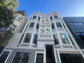 San Francisco apartment for rent - A tall building with a white facade and a balcony on the second floor.