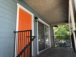 San Francisco apartment for rent - A blue house with a red door and a black railing.