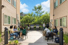 San Francisco apartment for rent - A group of people are sitting around a table outside of a building.