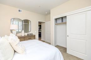 Bakersfield apartment for rent - a bedroom with a white bed and a closet