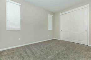 Bakersfield apartment for rent - an empty bedroom with white doors and a carpeted floor