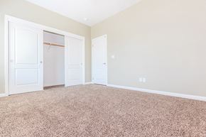 Bakersfield apartment for rent - a bedroom with two closets and a carpeted floor
