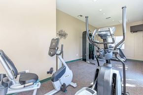 Bakersfield apartment for rent - the gym at the preserve at polo towers is equipped with exercise bikes and weights