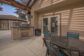 Bakersfield apartment for rent - a patio with a grill and a table with chairs