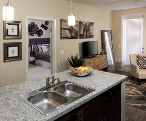 Bakersfield apartment for rent - a kitchen with a sink and a granite counter top