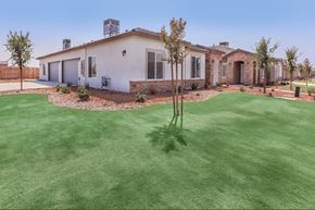 Bakersfield apartment for rent - a backyard with a house and a yard with green grass