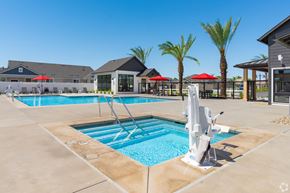 Bakersfield apartment for rent - A swimming pool with a sun lounger and umbrella.