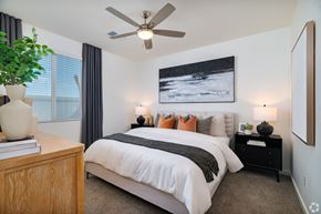 Bakersfield apartment for rent - a bedroom with a large bed and a ceiling fan